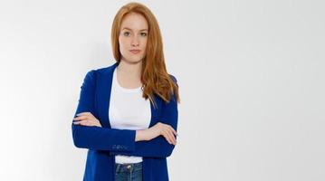 Happy red haired business woman in template blank white t shirt and stylish jacket isolated on gray background. Self career and job consulting knowledge. Young ceo entrepreneur and casual clothes photo