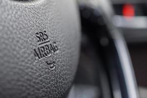 Safety airbag sign on car steering wheel with horn icon photo
