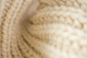 closeup beige knitted woolen fabric background photo