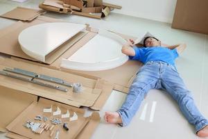 Man assembling white round table furniture at home photo