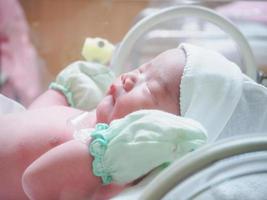 newborn baby infant sleep in the incubator at hospital photo