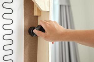 Man assembling sofa furniture at home photo