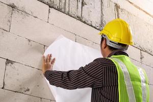 trabajador ingeniero profesional en el sitio de construcción de la casa foto