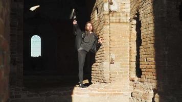 Beautiful athletic woman with a tough stretch doing the splits standing up in an abandoned building. Slow motion video