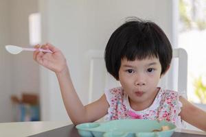 Little asian girl having breakfast photo