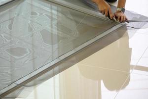 man install mosquito net wire screen on house window protection against insect photo