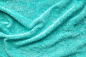 Green towel fabric texture surface close up background photo