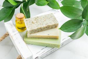 Olive Oil Soap bars on a wooden tray. Handmade natural soap. Spa natural treatments. photo