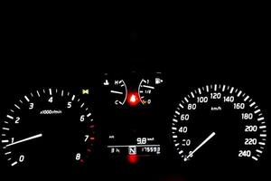 Dashboard speedometer car automobile at night light.