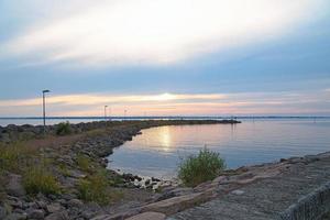 Sunset in Sweden at the harbor of lake Vaettern. Landscape shot in Scandinavia. photo