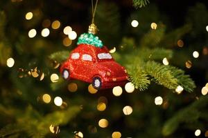 Toy red car on the Christmas tree photo