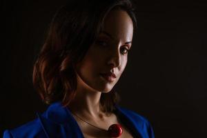 Close-up portrait of a beautiful woman, dark photo on a black background