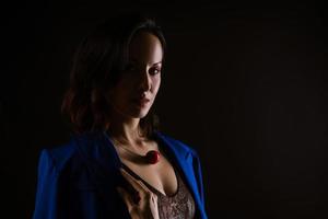 Close-up portrait of a beautiful woman, dark photo on a black background