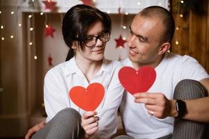 couple in love holding a red heart in their hands photo