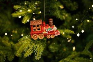 red toy locomotive hanging on the Christmas tree photo
