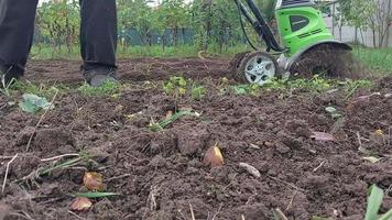 KYIV OBLAST, UKRAINE - OCTOBER 02, 2022 Cultivation of beds with a manual electric cultivator video