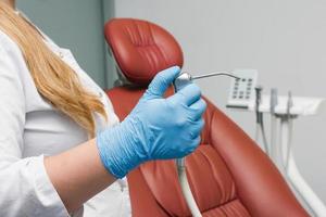 A water-air gun from the installation of a dental chair in the hands of a doctor photo