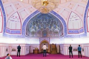 Bukhara, Uzbekistan. December 2021. Interior and worshippers at the Bolo House Mosque photo