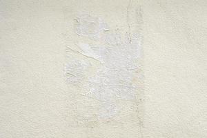 Old ripped torn grunge white poster texture on concrete wall background photo