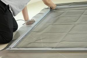 man install mosquito net wire screen on house window protection against insect photo