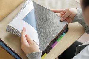 female designer with fabric color samples choosing textile for curtains photo