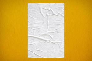 Blank white wheatpaste glued paper poster mockup on concrete wall background photo