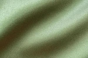 Green fabric texture background close up photo