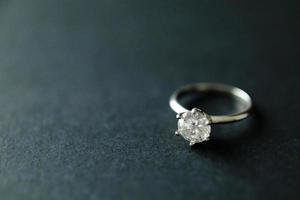 Diamond ring on black texture background photo