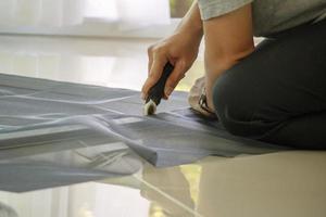man install mosquito net wire screen on house window protection against insect photo