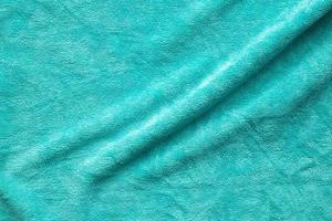 Green towel fabric texture surface close up background photo