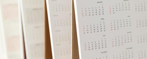 Close up calendar page dates and month background business planning appointment meeting concept photo