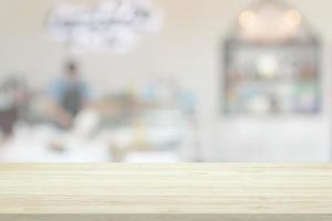 Empty wood table top with cafe restaurant interior blur background photo