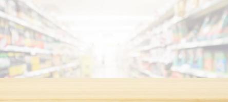 Wood table top with supermarket grocery store blurred background with bokeh light for product display photo