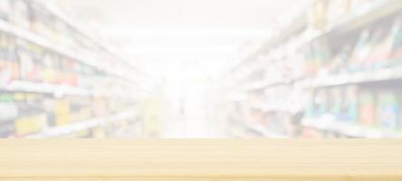 Wood table top with supermarket grocery store blurred background with bokeh light for product display photo