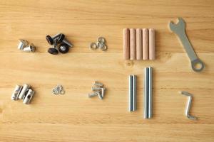 Assembly furniture tool kit with screw dowel wrench and bolt on wood table photo