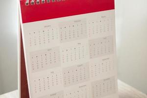Calendar page close up with white wall background business planning appointment meeting concept photo