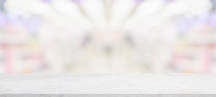Marble table top with supermarket grocery store blurred background with bokeh light for product display photo