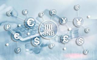 Different currencies on a virtual screen. SNB. Swiss National Bank. photo