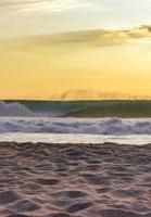 Colorful golden sunset big wave and beach Puerto Escondido Mexico. photo