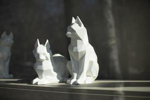 Cubic figures of cats. Sculpture of white cat. Interior item. photo