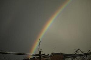 Rainbow in sky. Beautiful weather. Decomposition of light into colors. photo