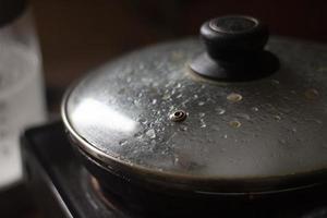 Frying pan in kitchen. Lid on frying pan. Cooking. photo