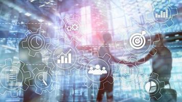 Business process automation concept. Gears and icons on abstract background photo