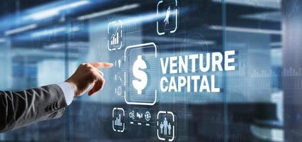 Venture capital. Investor capital. Businessman pressing virtual screen inscription photo