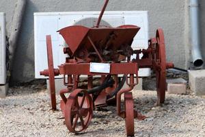 Old agricultural machinery stands on the street in Israel and rusts photo