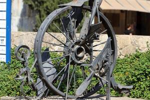 Old agricultural machinery stands on the street in Israel and rusts photo