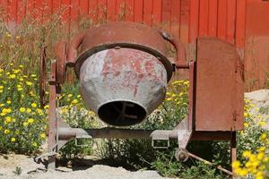 Old agricultural machinery stands on the street in Israel and rusts photo