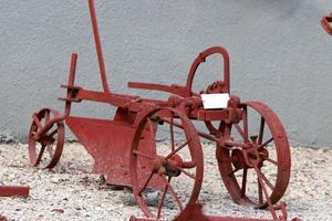 Old agricultural machinery stands on the street in Israel and rusts photo