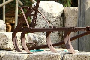 Old agricultural machinery stands on the street in Israel and rusts photo