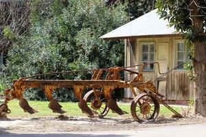 Old agricultural machinery stands on the street in Israel and rusts photo